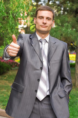 young businessman with thumb up