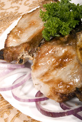 Fried juicy meat served with vegetables