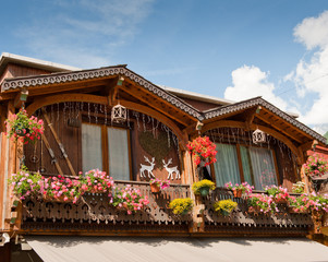 French Alpine wooden house decorated with flowers - 26644253