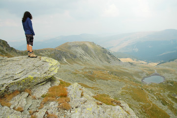 Woman on the top of a high mountain