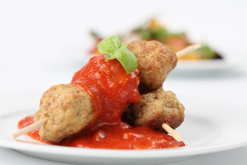 Roast meatballs on skewers and tomato dip. Shallow DOF