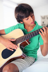 Fototapeta premium Boy with acoustic guitar