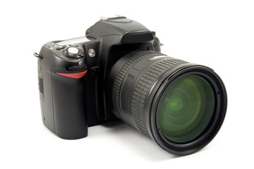 photo camera with zoom lens over white