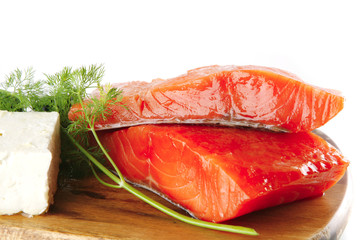 smoked salmon on wooden plate with white cheese