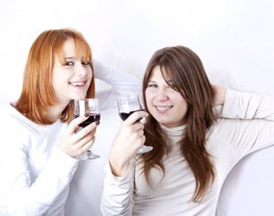 Obraz na płótnie Canvas Two girlfriends with two glasses of wine.