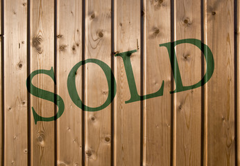 Sold. On a wooden wall background. Closeup, front view.