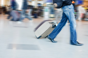 Man rushing to catch his flight in airport