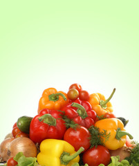 A pile of fresh and tasty vegetables on a green background