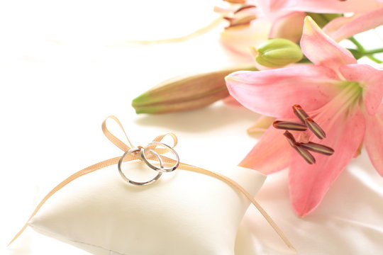 Pink Lily and a pair of wedding ring