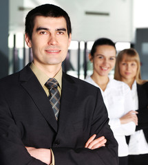 Three young and happy businesspersons in formal clothes