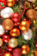 Colorful Christmas balls and cones on spruce branches