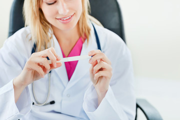 Close-up of a female doctor looking at temperature results