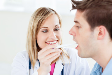 Portrait of a female doctor taking a saliva sample of a patient