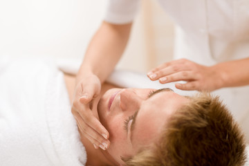 Fototapeta na wymiar Male cosmetics - facial massage in salon