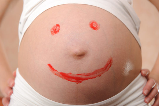 Pregnant's belly smiling