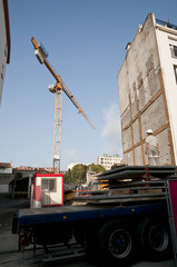Fototapeta na wymiar Worker waiting a crane to carry concrete plaks