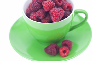 raspberry, saucer and cup is isolated on a white