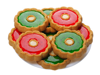 Cookies with red and green jelly on white plate, isolated