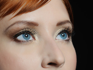 Beautiful macro shot of blue eyes with long lashes and make-up i