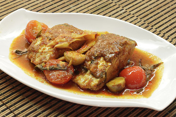 Wolf-herring fish served with garnishing