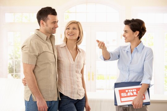 Estate agent and couple in new house