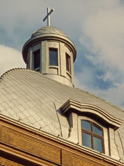 Fototapeta na wymiar Church tower with iron roof and dormer