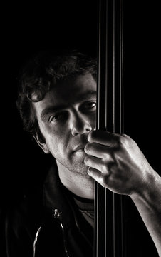 handsome musician  posing with fretless electric bass