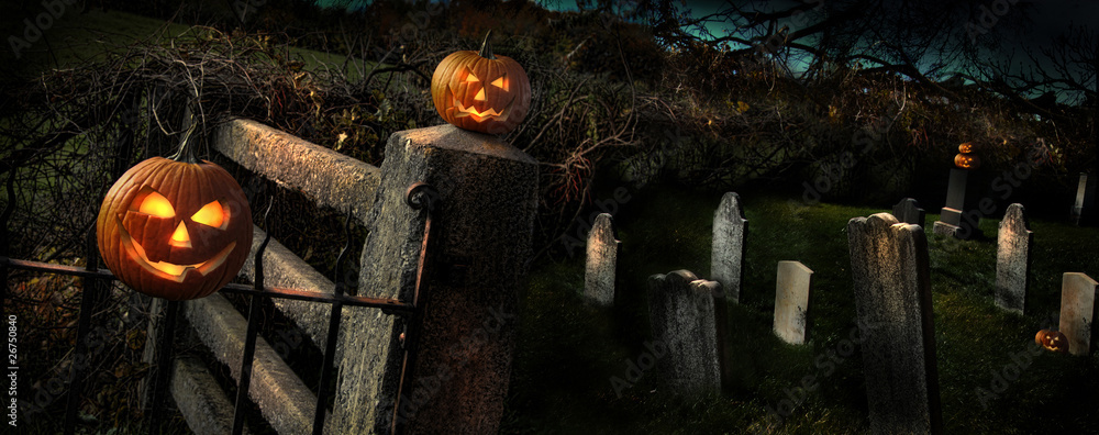 Wall mural Two Halloween pumpkins sitting on fence