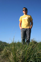 Teenage guy against blue sky