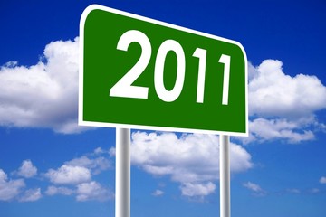 2011 green signpost against blue cloudy sky background.