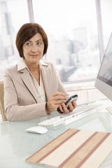 Mature businesswoman using smartphone