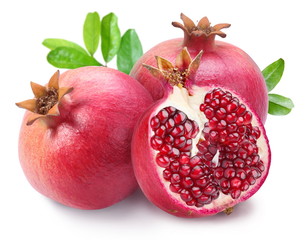 Juicy opened pomegranate with leaves.