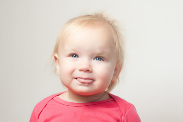 Fototapeta premium Portrait of cute young baby sit on chair and grimacing