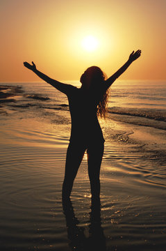 Silhouette of a woman at the sunset