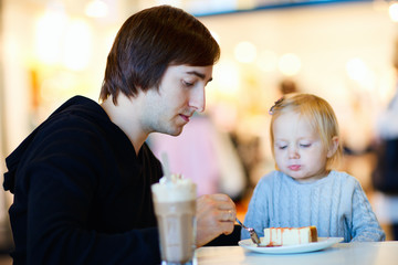 Father and daughter at cafe