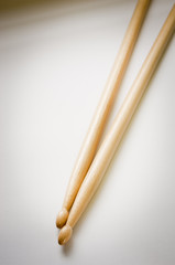 Wooden drum sticks or drumsticks on white in shallow focus
