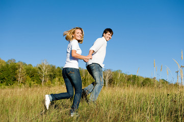Naklejka na ściany i meble young couple running outdoors