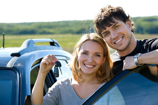 Happy Couple Near New Car Outdoors