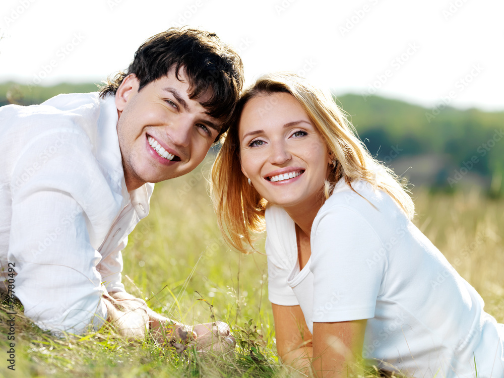 Wall mural happy cheerful beautiful couple on nature