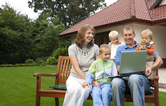 Family Watching Laptop Outdoors