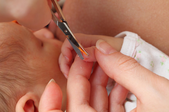 Mother Cutting Little Baby's Fingernails