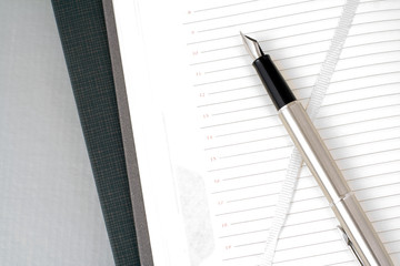 Open organizer and silver pen. Still life.