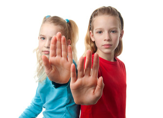 twogirls making stop sign with hand over white background