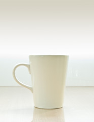 One ceramic cup with warm light background