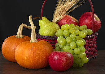 Autumn basket: Apple, pear, grapes, wheat, pumpkin