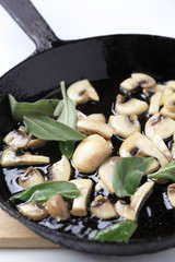 Button mushrooms on a pan