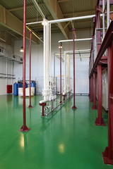Fototapeta na wymiar Pipes, tubes, machinery at factory pumphouse