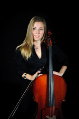 Young cellist standing and smileing on black background