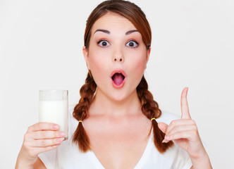 young woman holding glass of milk