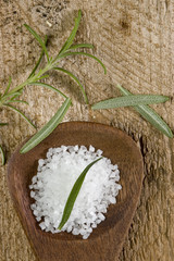 sea salt with herbs in a wooden spoon